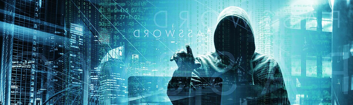 Symbolfoto für das Thema Cyberkriminalität. Das Foto zeigt eine Person mit Kapuze, deren Gesicht nicht zu erkennen ist.
